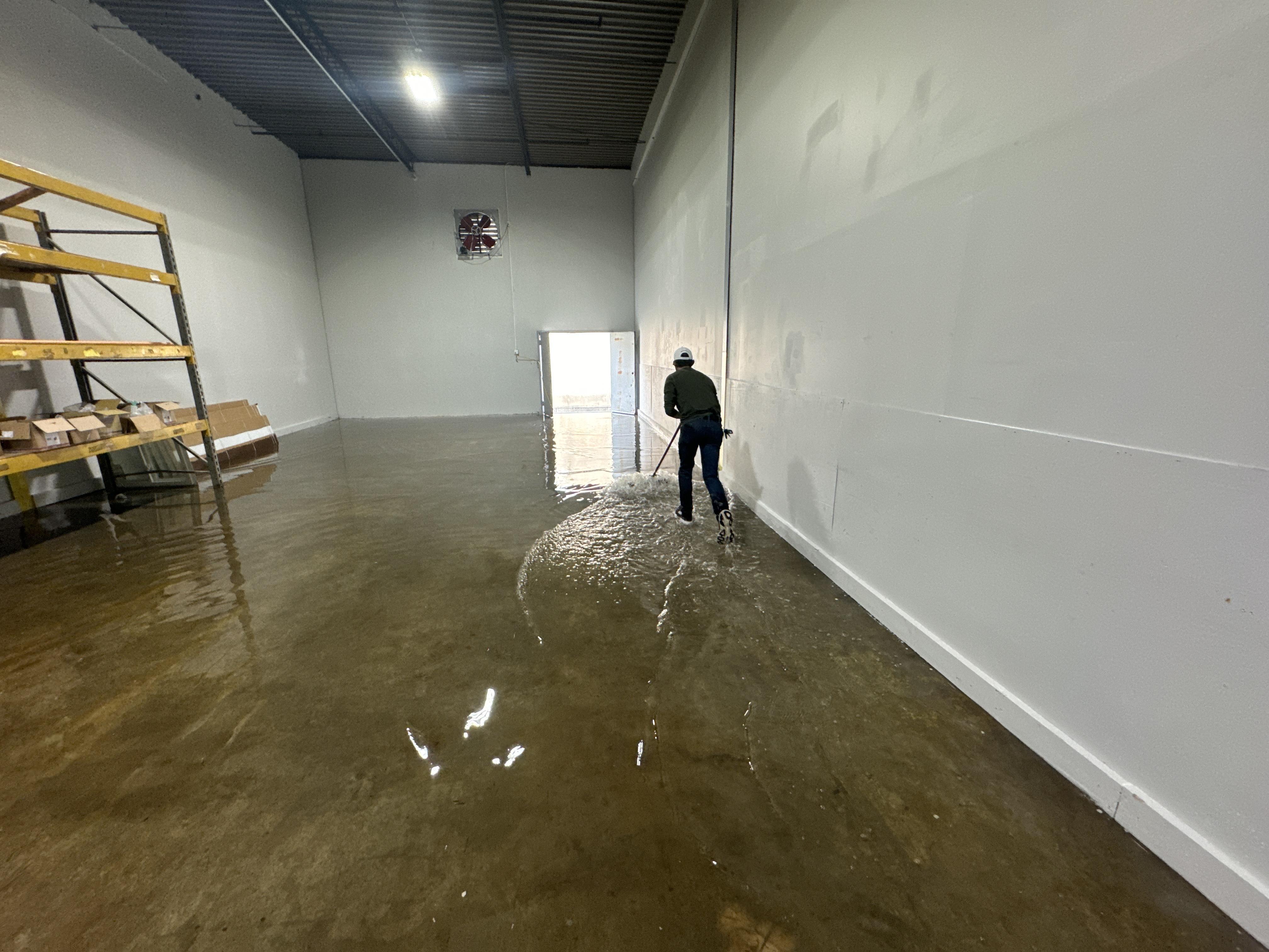 IRS crew member extracting standing water from a Knoxville commercial building