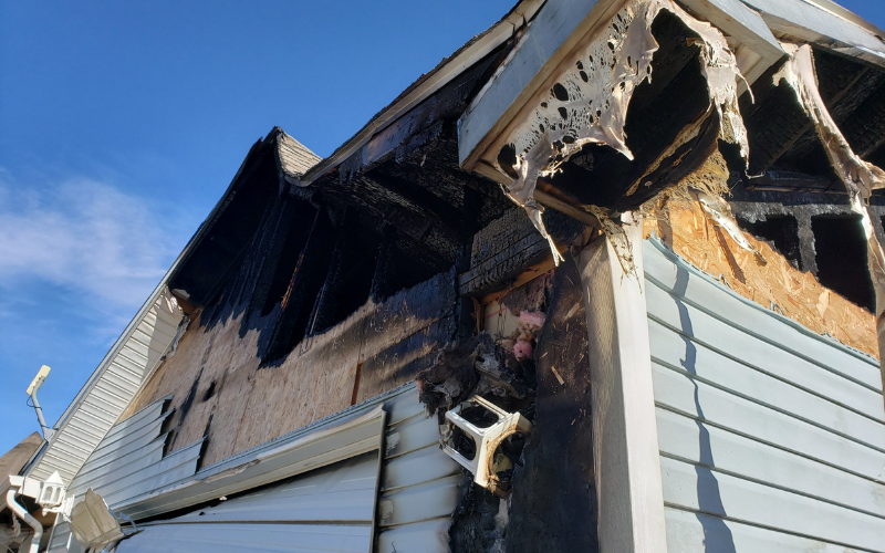 Exterior of a Knoxville house with fire damage to roof and siding